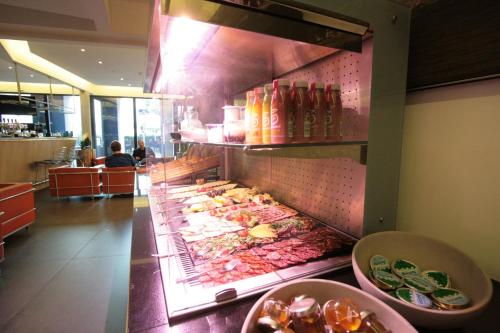 a buffet line with food in a restaurant at Amosa Liège City Centre Apart Regence 10 in Liège
