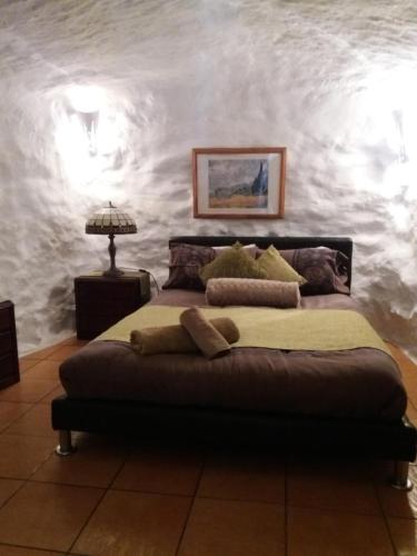 a bedroom with a large bed in a room at Pico Piedras in Zújar