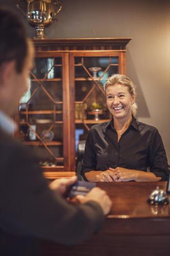 a woman sitting at a table in front at Best Western Hotel Varnamo in Värnamo