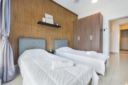 two beds in a hotel room with white sheets at Seasons Luxury Apartment By RR JBcity in Johor Bahru