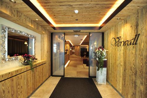 a hallway with a entrance to a hotel with a sign on the wall at Hotel Verwall in Ischgl