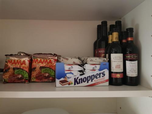 a shelf with some food and wine bottles on it at Studio direkt am Bodensee in Thal