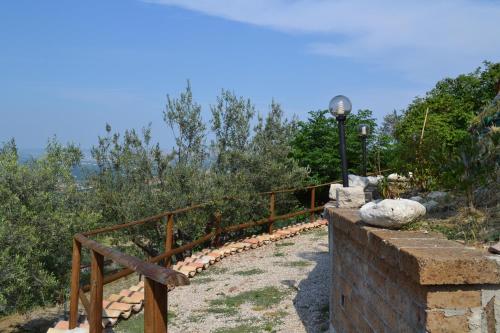 a stone fence with a light on the side of a hill at Giardinotto Casa vacanze in Altino