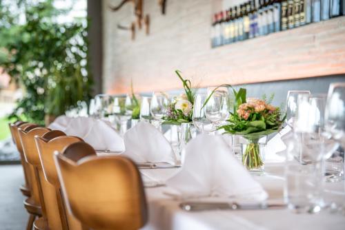 a table with white table cloths and flowers on it at Hotel Schützenhaus in Uznach