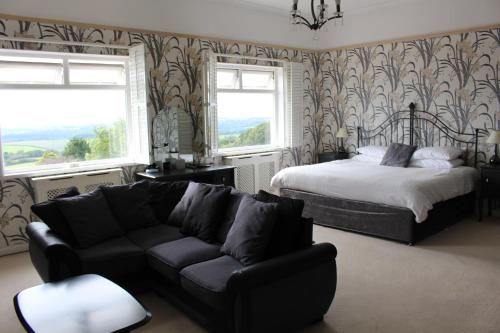 a living room with a bed and a couch at The Moorland Hotel in Wotter