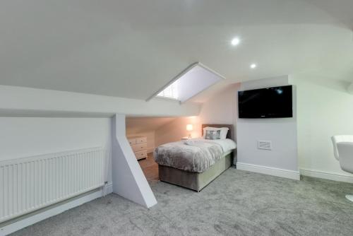 a attic bedroom with a bed and a sink at RST Rodney Street in Liverpool