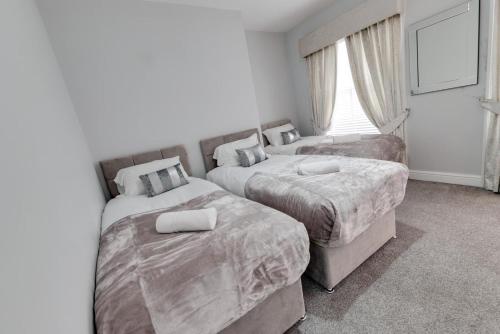 a bedroom with two beds and a window at RST Rodney Street in Liverpool