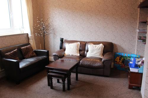 a living room with a couch and a coffee table at The Moorland Hotel in Wotter