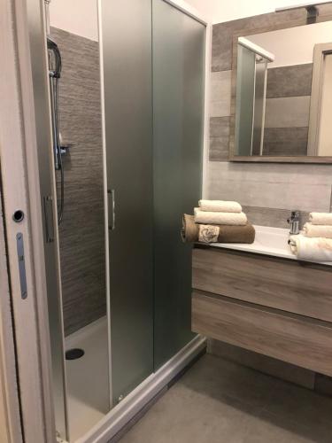 a bathroom with a glass shower and a sink at Carpe Diem in Lamezia Terme