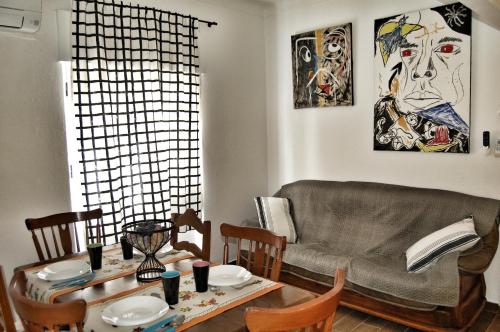 a living room with a table and a couch at Casa das 4 estações in Castelo Branco