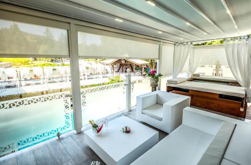 a room with a bed and a large window at Spa Hotel Rich in Velingrad