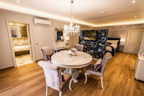 a dining room and living room with a table and chairs at Spa Hotel Rich in Velingrad