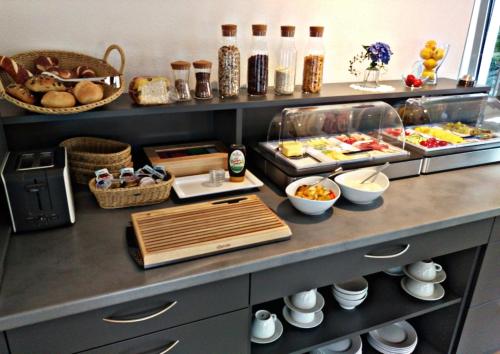 a buffet with many different types of food on a counter at Pension Yvonne - SUPERIOR in Rust