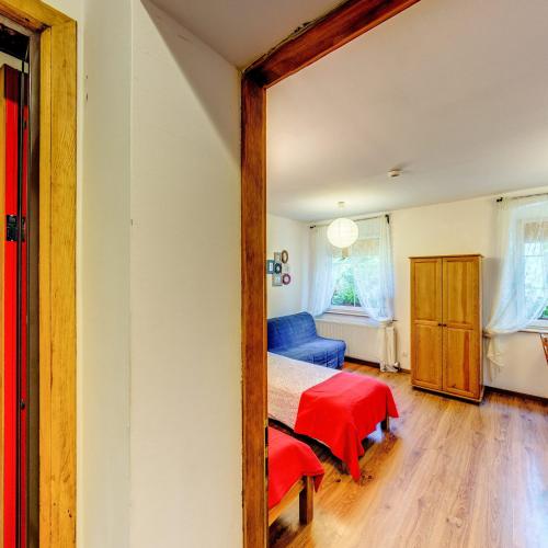 a bedroom with a bed and a mirror at Leśne Apartamenty in Zieleniec