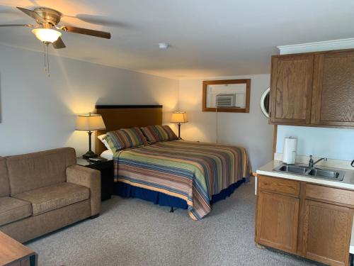 a bedroom with a bed and a couch and a sink at Maple Lane Empire in Empire