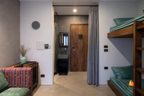 a bedroom with a bunk bed and a bathroom at Deja Vu House Ha Long in Ha Long