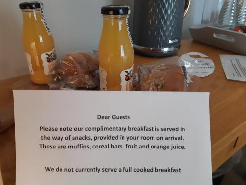 two bottles of orange juice sitting on a table at The Masons Arms in Harrogate