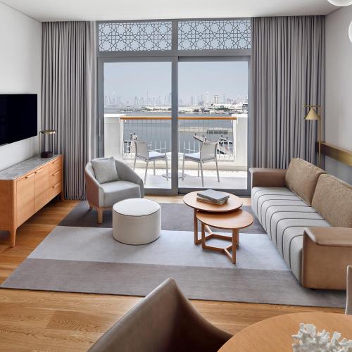 a living room with a couch and a table at Vida Creek Harbour in Dubai