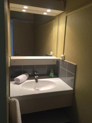 a bathroom with a sink and a mirror at VVF Île de Ré Sainte-Marie-de-Ré in Sainte-Marie-de-Ré