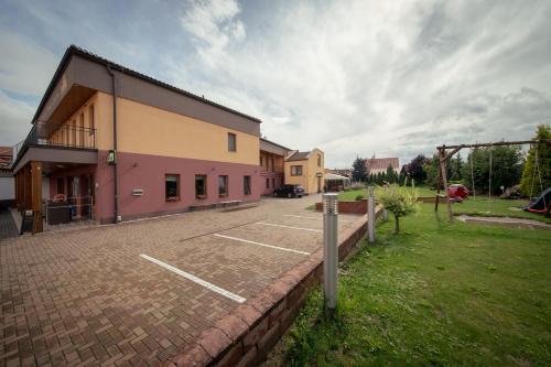 a parking lot in front of a building at Penzion u Bláhů in Dolany