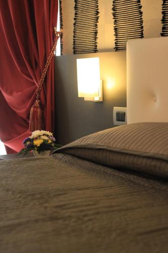 a bedroom with a bed with a red curtain at Giulimà B&B in Rocchetta SantʼAntonio