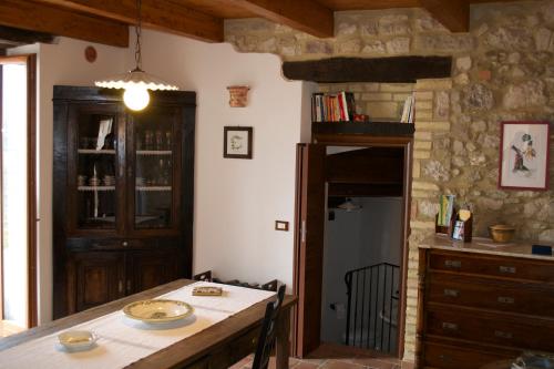 a kitchen with a table and a dining room at Giardinotto Casa vacanze in Altino