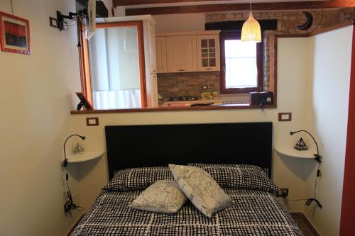 מיטה או מיטות בחדר ב-Giardinotto Casa vacanze
