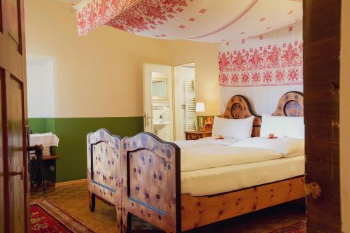 ein Schlafzimmer mit einem großen Bett mit einem Holzrahmen in der Unterkunft Gasthof Eberhard - Hof, Wirtshaus & Herberge in Sankt Michael in Obersteiermark