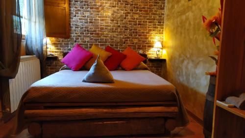 a bedroom with a bed with colorful pillows at Mille e una notte in San Severino Lucano