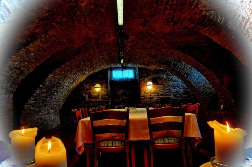 a dining room with candles and a table with chairs at Hotel Alte Linden in Altena