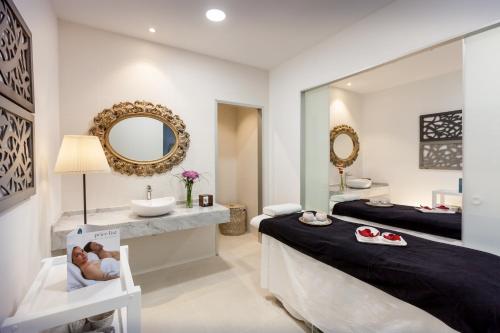 uma casa de banho com um lavatório e um espelho em Barceló Corralejo Sands em Corralejo