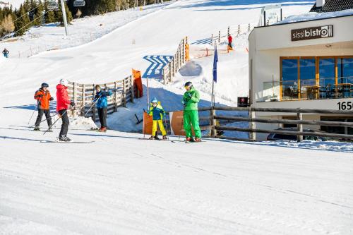 a group of people on skis in the snow at Sissi Park in Lachtal