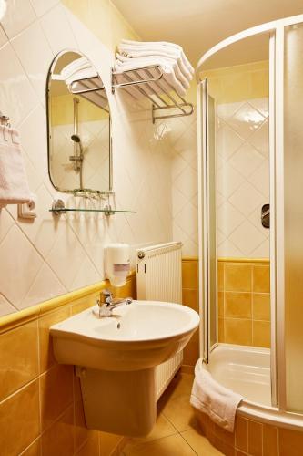 a bathroom with a sink and a shower at Panský dům - Jizerka in Jizerka