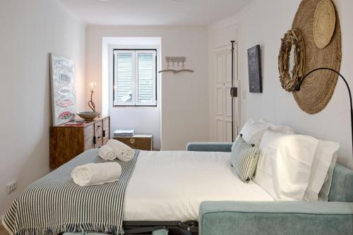 a bedroom with a large bed with towels on it at Charming Studio in Lisbon's center! in Lisbon