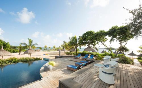 a resort with a swimming pool and lounge chairs at Radisson Blu Azuri Resort & Spa in Roches Noires