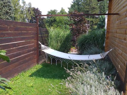 a hammock in a garden next to a fence at Laganini in Samobor
