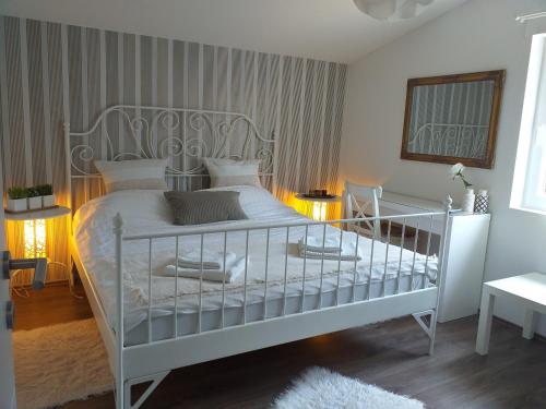 a bedroom with a white bed in a room at Laganini in Samobor