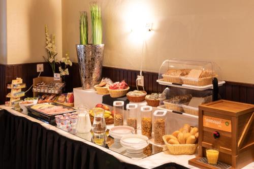 a table with food and other foods on it at Hotel "De Klok" in Buren