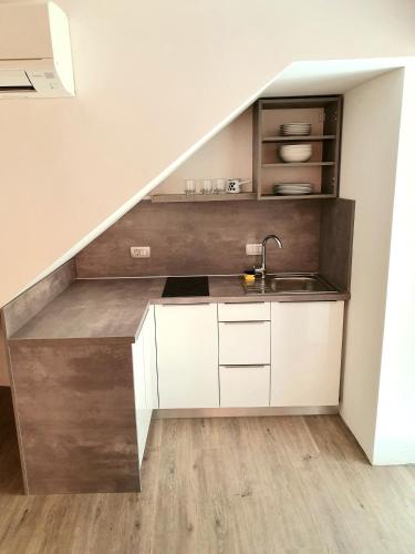 a kitchen under the stairs with a sink at Casa Orange 2 in Koper