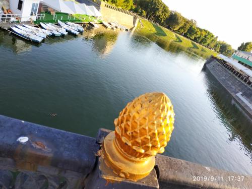 a waffle cone sitting on a fence next to a body of water at Apartments at Kontorska 10 in Kharkiv