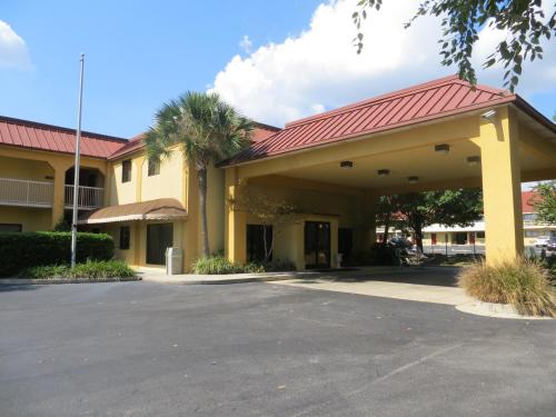 a building with a red roof and a parking lot at Fairview Inn & Suites Mobile in Mobile