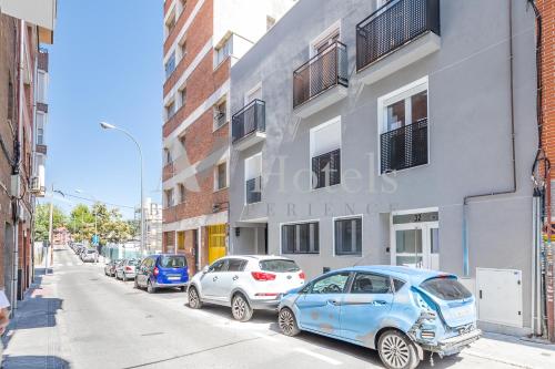 a row of parked cars parked on a city street at AYZ Villegas - Auto check-in property in Madrid