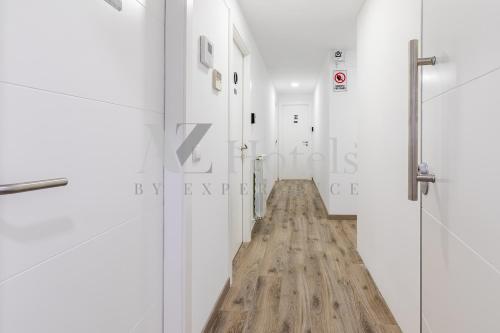 a hallway with white walls and a wooden floor at AYZ Villegas - Auto check-in property in Madrid