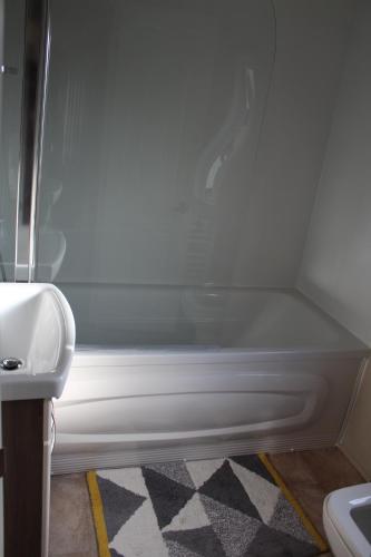 a bathroom with a sink and a bath tub at Moonlight Ridge -2 bedroom lodge with hot tub in Felton