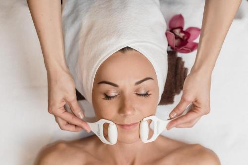 a woman in a spa with a towel on her head at Gradiali Wellness and SPA in Palanga