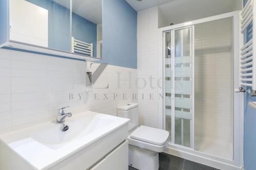 a white bathroom with a sink and a toilet at AYZ Villegas - Auto check-in property in Madrid