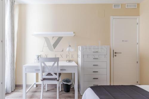 a bedroom with a desk with a chair and a dresser at AYZ Villegas - Auto check-in property in Madrid