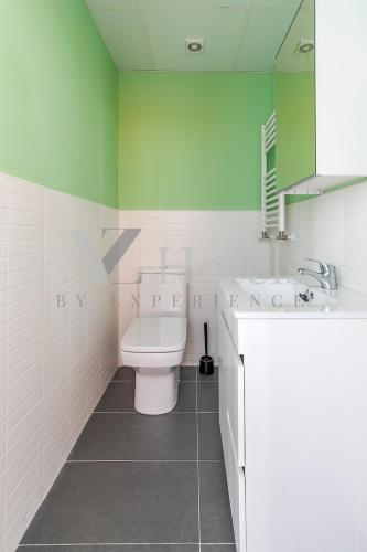 a bathroom with a toilet and a sink and a mirror at AYZ Villegas - Auto check-in property in Madrid
