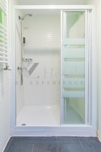 a shower with a glass door in a bathroom at AYZ Villegas - Auto check-in property in Madrid