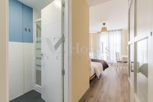a bedroom with a bed and a sliding glass door at AYZ Villegas - Auto check-in property in Madrid